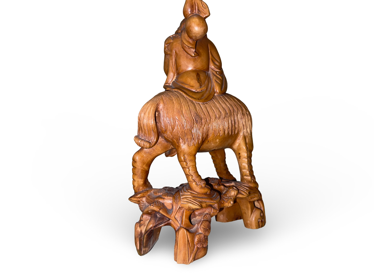 Carved Wooden Figure of an Elder on Mythical Beast